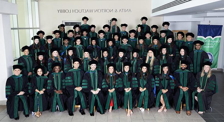 FAU Schmidt College of Medicine graduates taking group picture at 2024 commencement ceremony