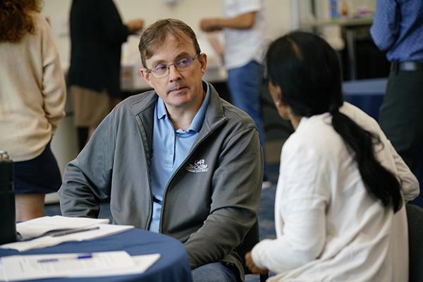 Faculty sitting at a table in the FAU Schmidt College of Medicine